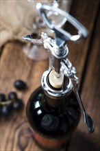 Red Wine (close-up shot) on vintage wooden background