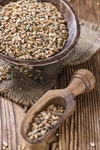 Mixed Cereals (wheat, rye, barley, oatand millet) on vintage wooden background