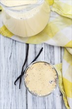 Fresh made Vanilla Milk (close-up shot) on wooden background