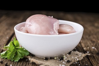 Fresh Chicken Fillet (selective focus, close-up shot) on vintage wooden background