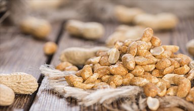 Portion of roasted Peanuts with spices and salt (close-up shot)