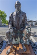 Bogense on the Kattegat, monument to the seated poet Hans Christian Andersen, fairytale figures,