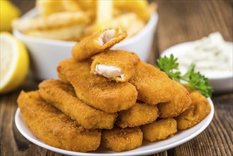 Fried Fish Fingers (selective focus) on wooden background (selective focus)