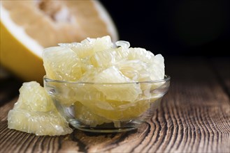 Fresh Pomelo (close-up shot) on vintage wooden background