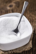 Old wooden table with white Sugar (selective focus, close-up shot)