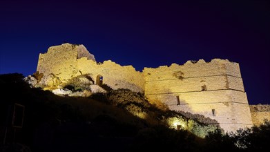 Night shot, A festively illuminated castle rises in the night, its stone walls glowing against the