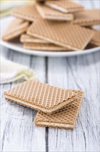 Crispy Waffles with Vanilla Cream (close-up shot) on wooden background