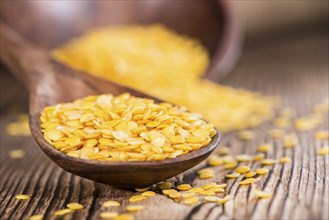 Portion of Yellow Lentils on vintage wooden background