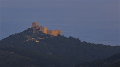 A castle on a hill in the first morning light, surrounded by natural landscape, Kritinia Castle, St