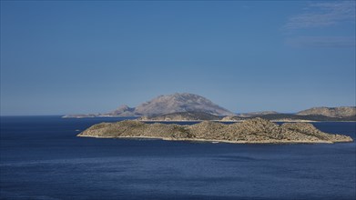 View of an island in the blue sea, surrounded by clear skies and wide expanses of water, Makri