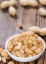 Portion of roasted Peanuts with spices and salt (close-up shot)