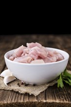 Portion of chopped Chicken Fillet (close-up shot) on wooden background