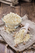 Heap of Chick Pea flour on an old wooden table