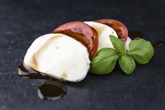 Portion of Mozzarella with Tomatoes (detailed close-up shot, selective focus)