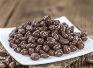 Chocolate Raisins (selective focus) on an old wooden background