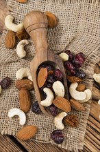 Wooden table with Trail Mix (selective focus, close-up shot)