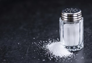 Salt Shaker on a slate slab (close-up shot, selective focus)