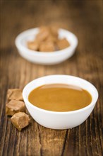 Portion of fresh Caramel Sauce (close-up shot, selective focus)