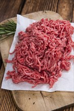 Portion of Minced Meat on an old wooden table (close-up shot)