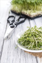 Fresh Cress (close-up shot) on rustic wooden background