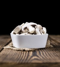 Portion of white Mushrooms (close-up shot) on vintage wooden background