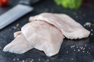 Slate slab with raw Chicken Cutlet (close-up shot)