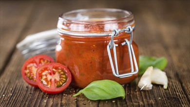 Pasta Sauce (Tomato taste) as high detailed close-up shot on a vintage wooden table (selective