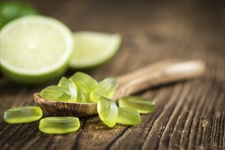 Gummy Candy with lime taste (selective focus) on wooden background