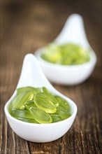 Portion of gummy candy (with lime taste) as close-up shot (selective focus)