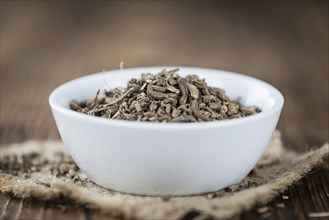 Valerian roots (dried, detailed close-up shot) on wooden background