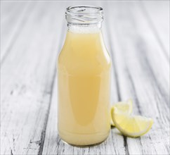 Fresh made Juice (lemon) on a vintage background (close-up shot)