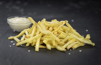 Portion of fresh made crispy French Fries (selective focus, close-up shot)