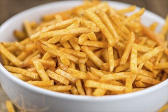 Portion of fried potato sticks (close-up shot, selective focus)