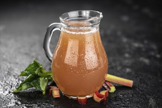 Rhubarb Juice on a rustic background (close up shot, selective focus)