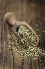 Portion of Stevia Leaves (dried, close-up shot) on wooden background