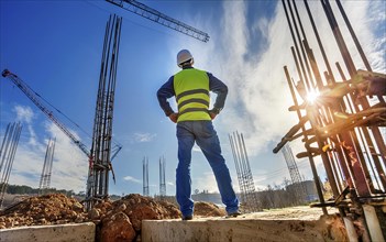 A civil construction engineer inspects a large construction site, civil construction engineering,