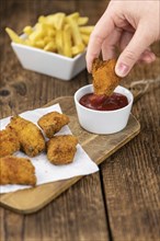 Homemade Chicken Nuggets on vintage background (selective focus, close-up shot)