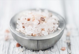 Pink Salt on a vintage background as detailed close-up shot (selective focus)