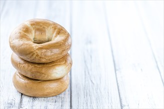 Plain Bagel (selective focus) on vintage background (close-up shot)