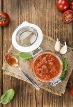 Fresh made Pasta Sauce (Tomato taste) on a vintage background (close-up shot)