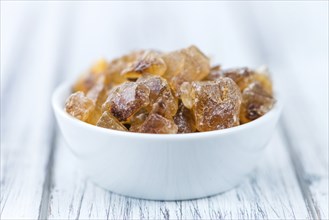 Brown Rock Candy on wooden background (selective focus, close-up shot)