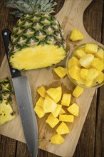 Fresh made Pineapple (sliced) on a vintage background as detailed close-up shot