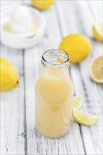 Fresh made Juice (lemon) on a vintage background (close-up shot)