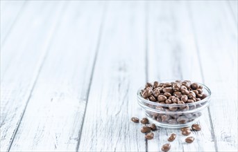 Portion of Chocolate Raisins on an old wooden table (selective focus, close-up shot)