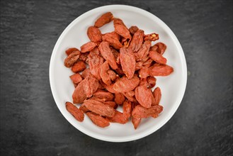 Goji Berries on a vintage background as detailed close-up shot (selective focus)