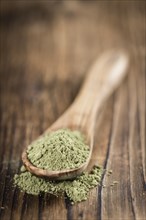 Stevia leaf powder (detailed close-up shot) on rustic wooden background