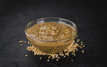 Fresh made German Cuisine (sweet Mustard) on a vintage background (close-up shot)