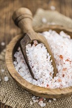 Himalayan Salt as high detailed close-up shot on a vintage wooden table (selective focus)