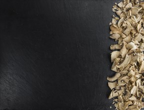 Some Dried white Mushrooms on a vintage slate slab, selective focus