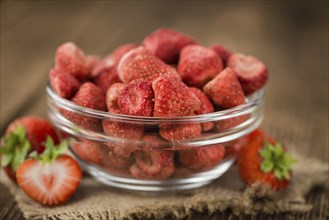 Dried Strawberries on rustic wooden background as close-up shot